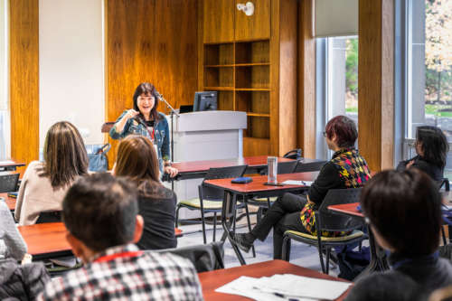 A woman teaches in a classrom